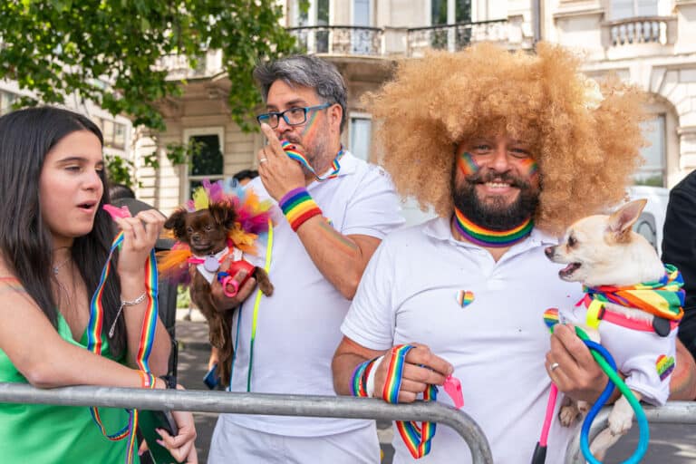 Member of the London Pride crowd with their dog and Elton John AIDS Foundation whistles